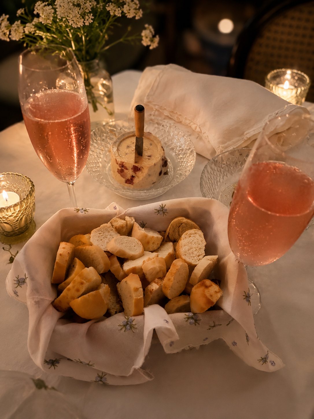 Mesa refinada com pães, mousse e espumante rosé